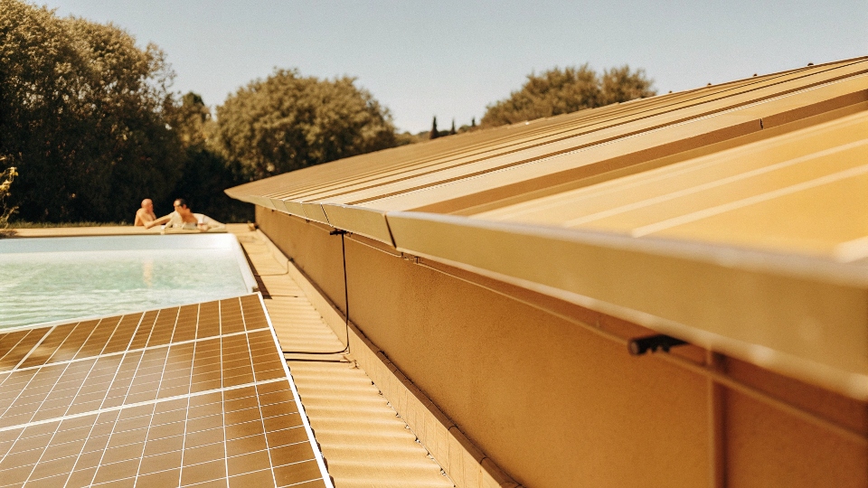 A solar pool pump system with solar panels installed next to a sparkling blue swimming pool